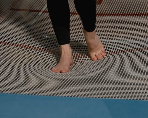 Close-up of a person's feet on a mat, showing stability and focus.