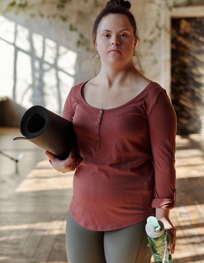 Spacious, bright room with a yoga mat, ready for an exercise session.